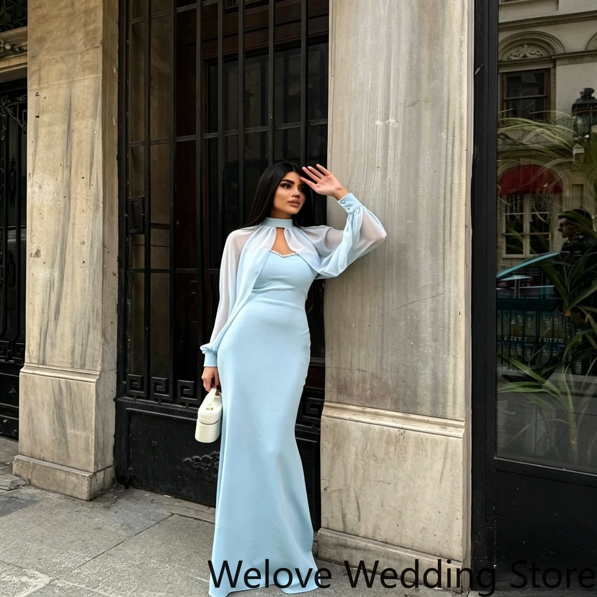 

Blue Formal Evening Gown Featuring Form-Fitting Mermaid Silhouette Delicate Beaded Neckline Sheer Chiffon Cape with Long Sleeves