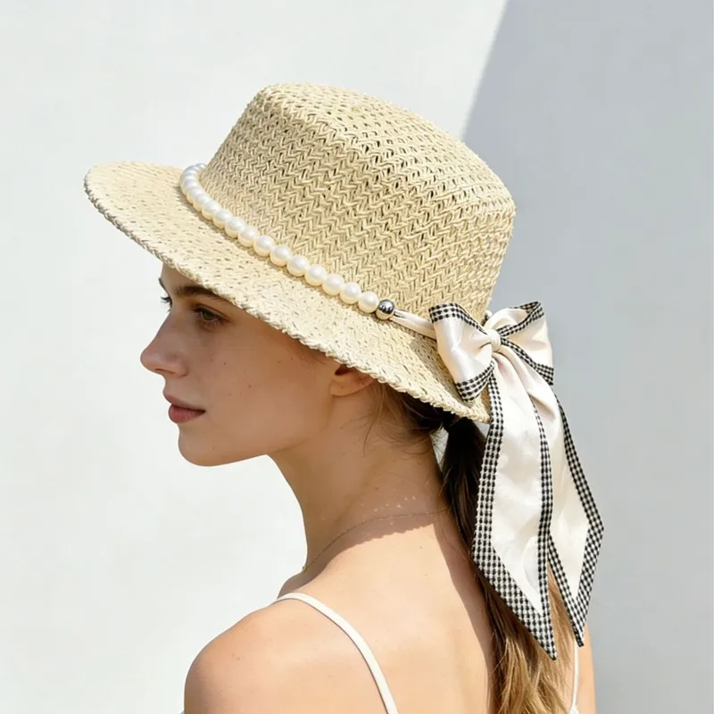 Pearl-embellished hat with a flowing brim, offering UV , perfect for beach vacations and sun protection, in a Fren