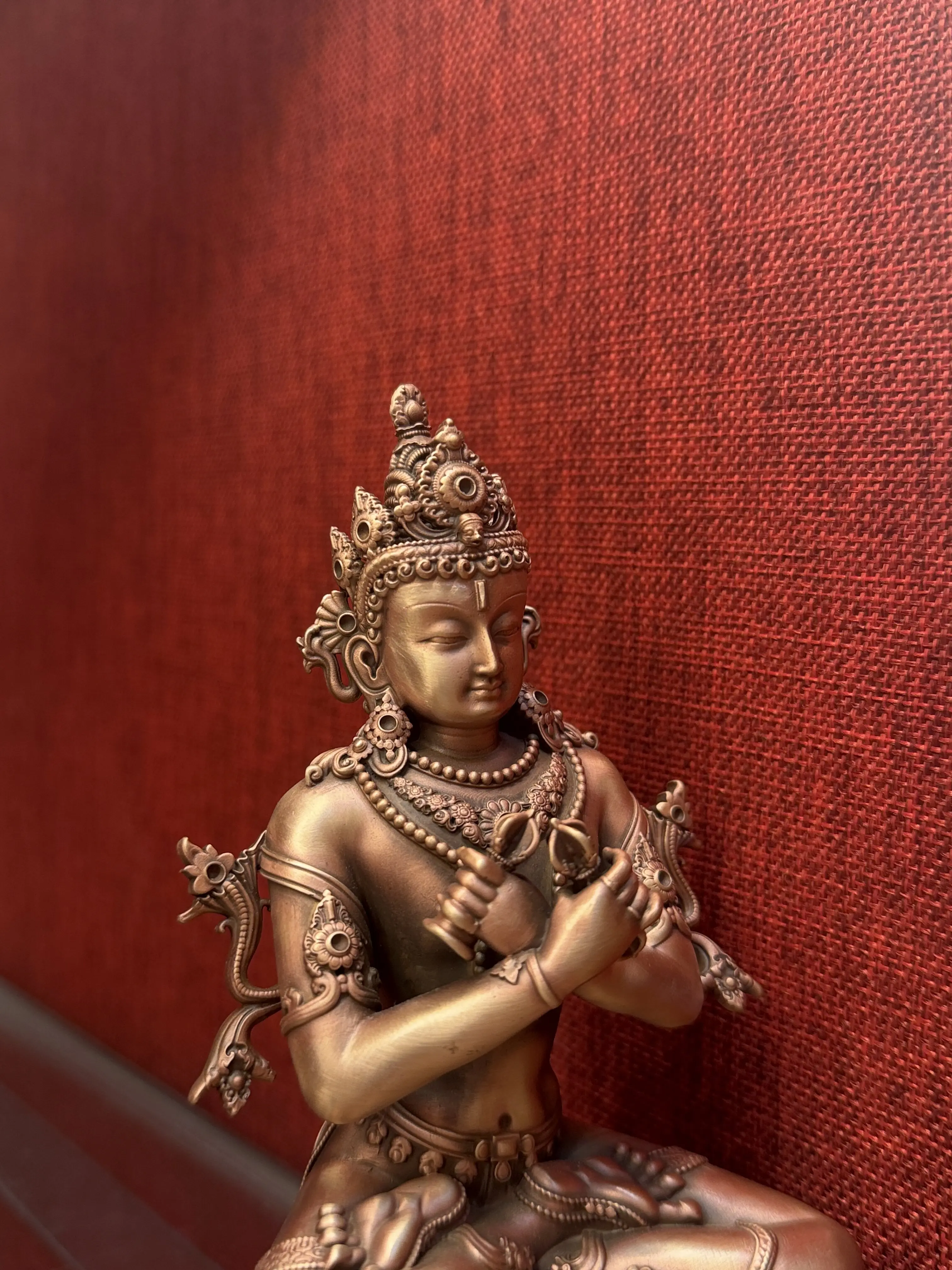 The Vajra Zongzha is a pure red copper Buddha statue from the Zhana Baza period, standing 15 centimeters tall