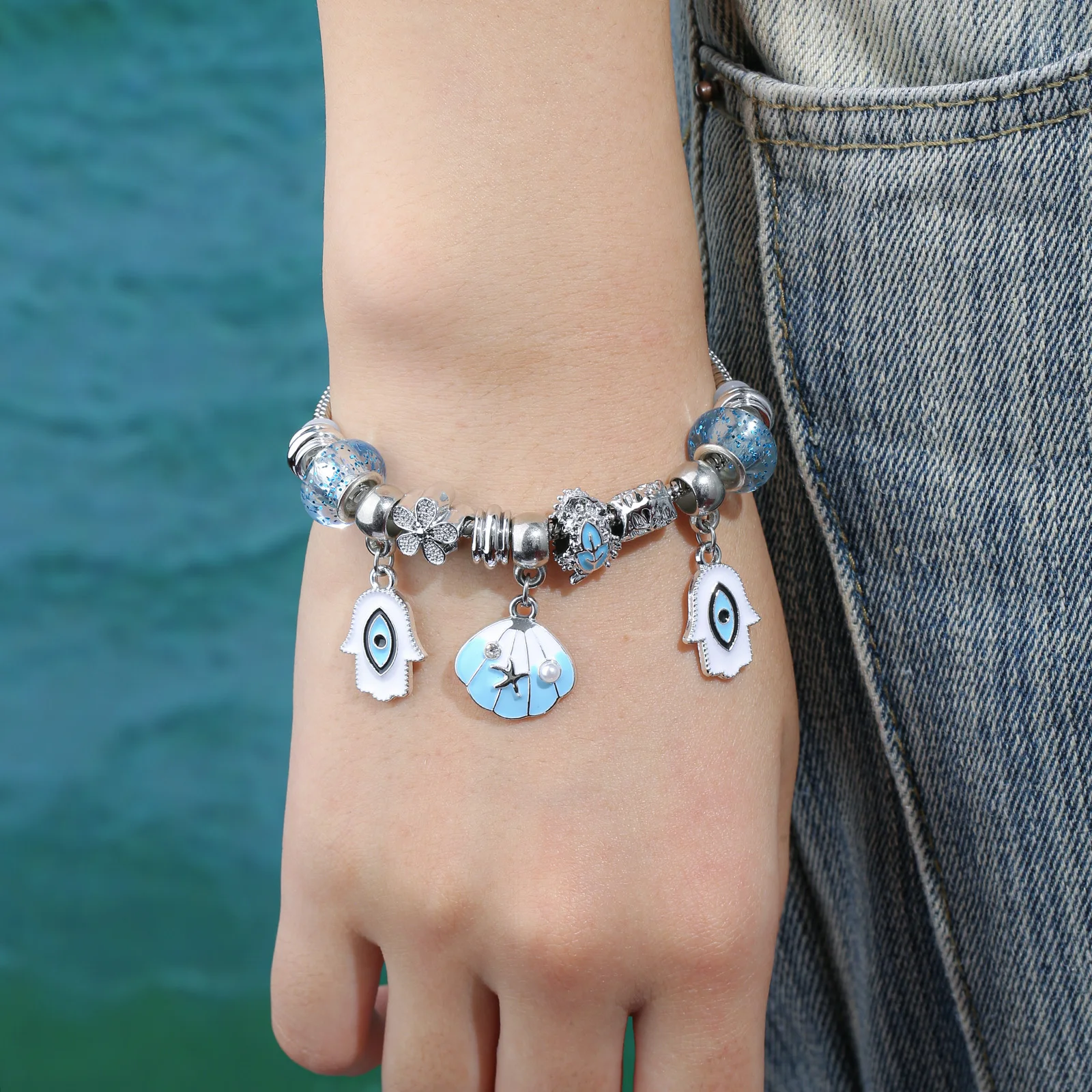 

Silver Tone Evil Eye Hamsa Charm Bracelet with Shell Pendant for Women