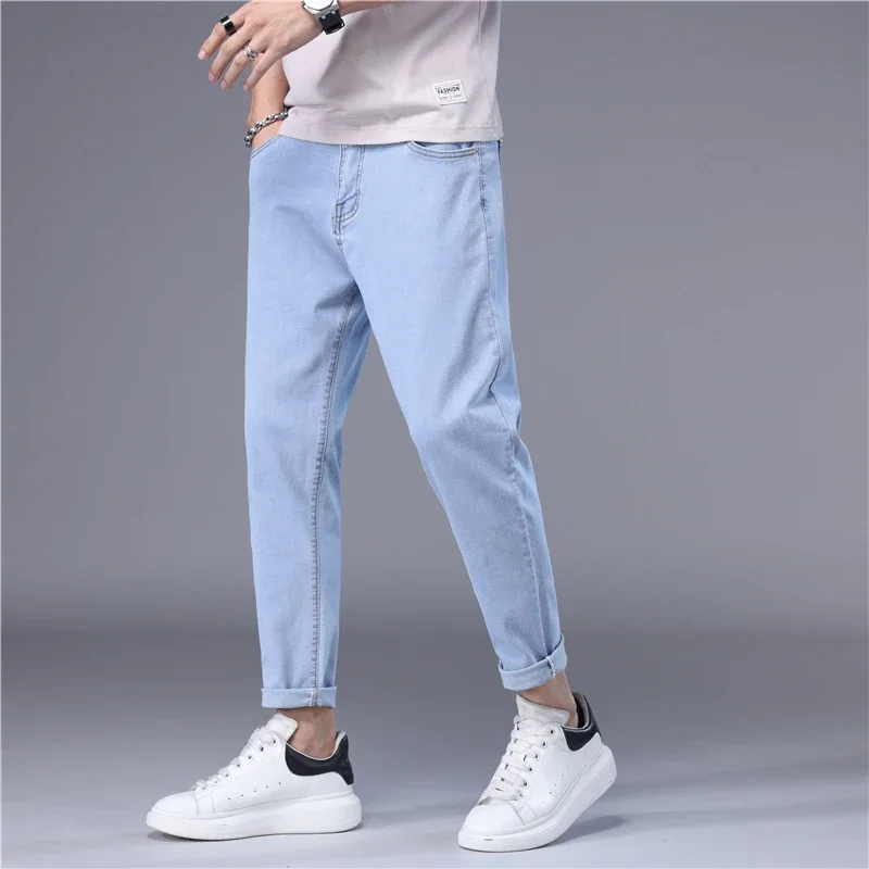 ฤดูร้อนกางเกงยีนส์ผู้ชายบางสไตล์เกาหลีสีฟ้าสีดําสีทึบยืดตรงสไตล์ SLIM FIT เท้า DENIM Cropped กางเกงชาย