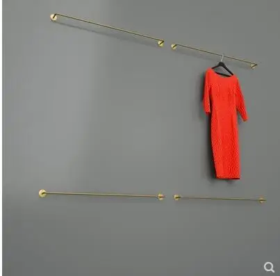 

A stainless steel brushed silver titanium gold hanging rod is hung on the wall of the clothes rack display rack in the clothing