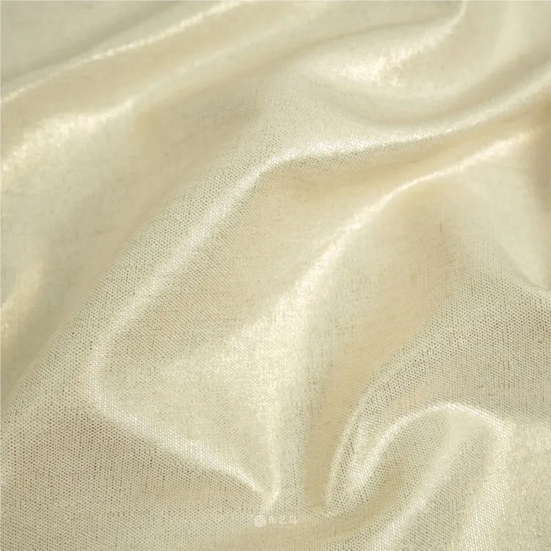 This coat is made of handcrafted fabric featuring crisp and stylish beige gold luster coating with gold-embossed linen base