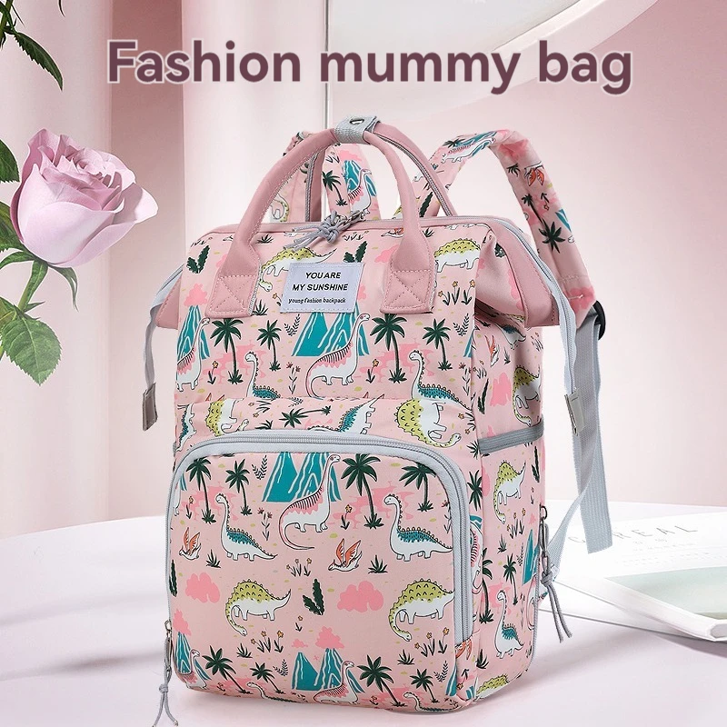 A lady hand-held mini mummy bag, cute dinosaur print backpack, suitable for daily use with a baby