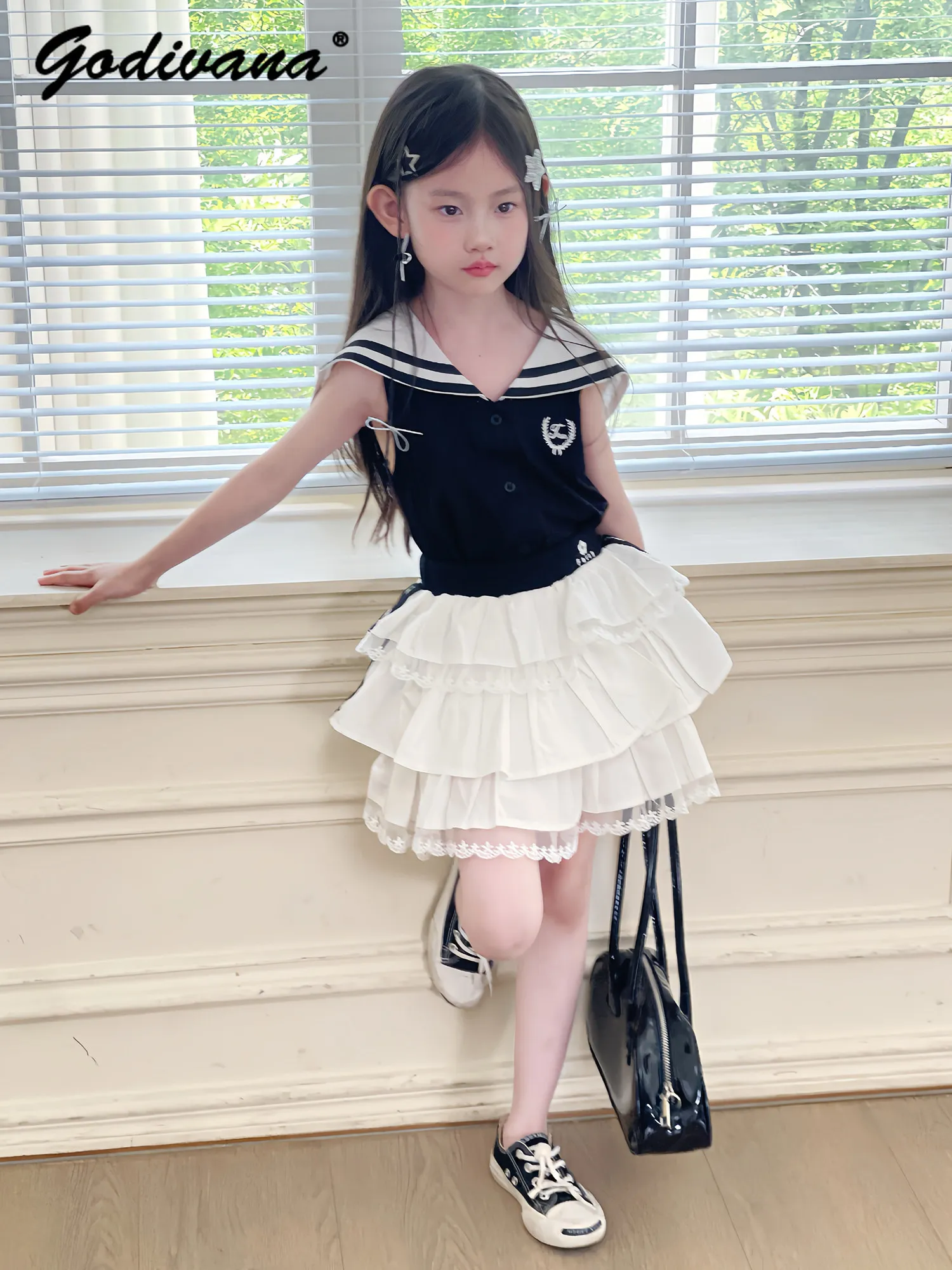 

Baby Girls Summer 2026 New Fashion Outfit Childrens Black Sleeveless Navy Collar Top and White Lace Trim Cake Skirt 2pcs Set