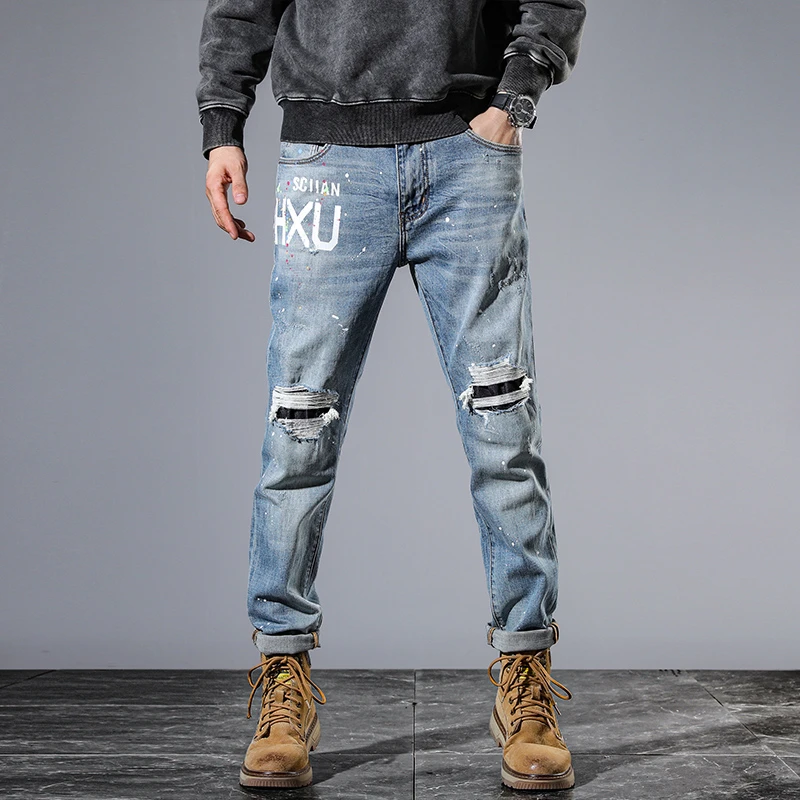 High-end personalised biker ripped patch patch men's jeans vintage washed ins light blue printed spray-painted trousers