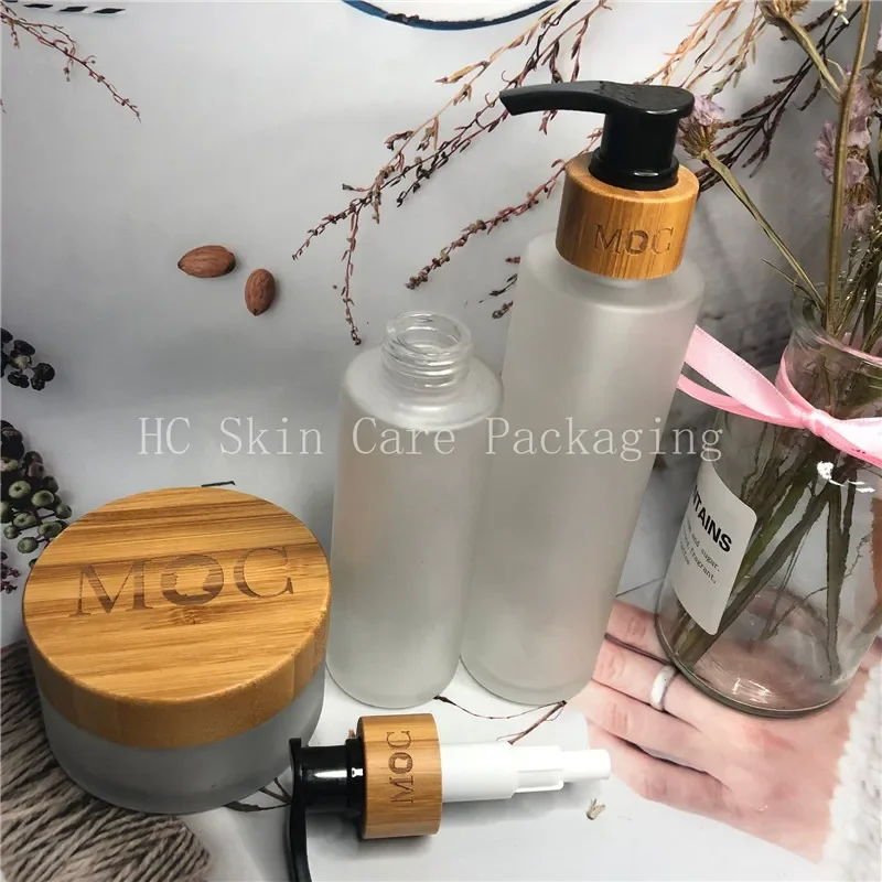 Venda tampa à prova de crianças transparente fosco ombro plano óleo essencial cosméticos garrafa de loção de vidro de bambu, garrafa de vidro de loção doméstica