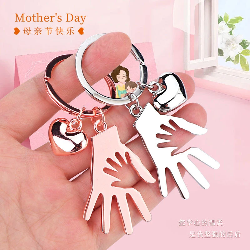 keychain pendant with a hand holding another hand, exuding a sense of elegance