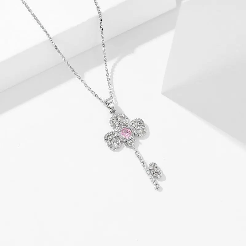 A one-shoulder necklace dress paired with a trendy and high-end designer key collarbone chain