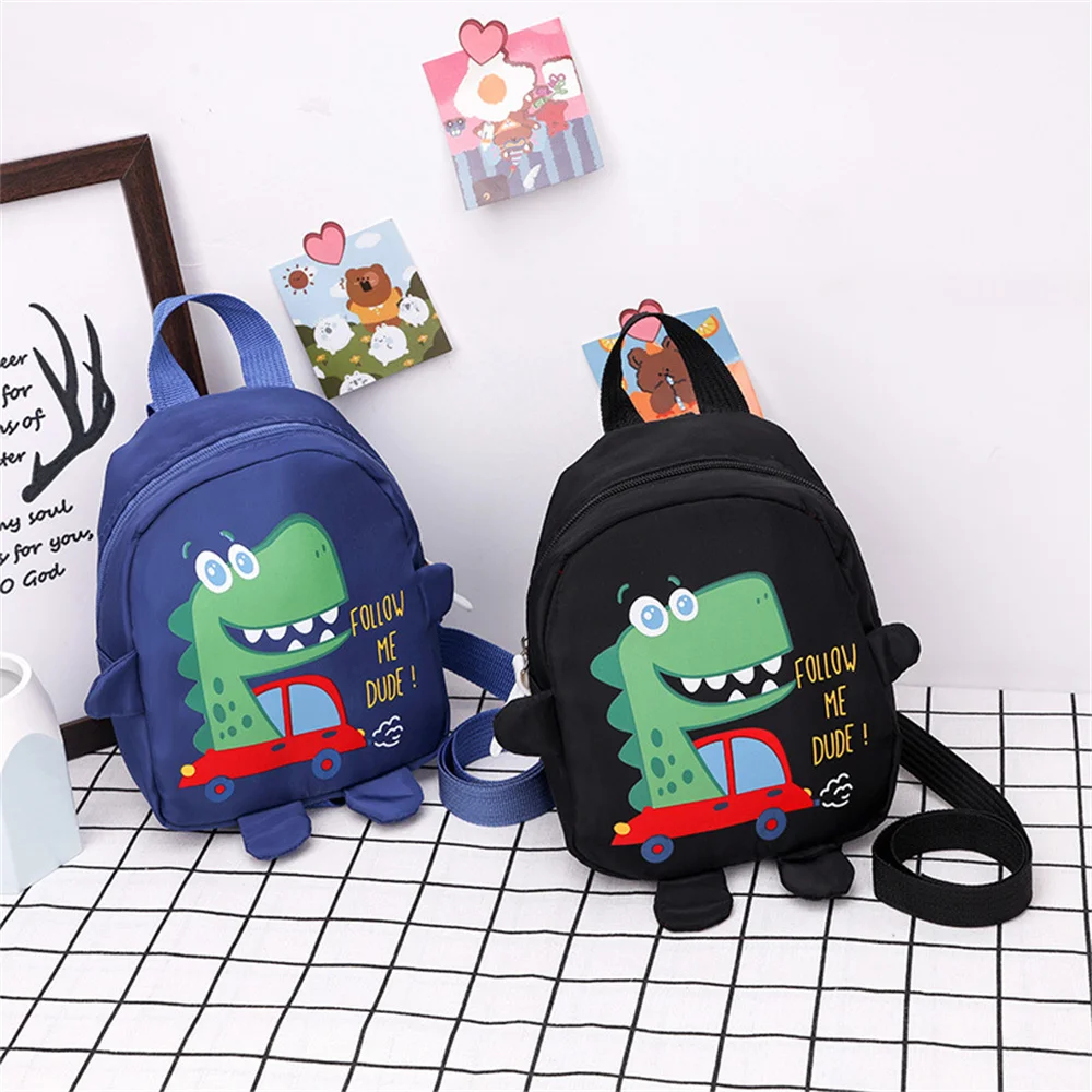 Mochila escolar para niños de jardín de infantes, bolso de hombro doble antipérdida con patrón de dinosaurio de dibujos animados, mochila de nailon para viajes