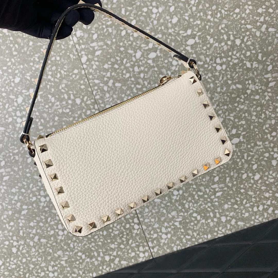 Chic Crossbody Bag with Iconic Hook Closure and Metal Accents. Dual Zipper Hook Closure Removable Shoulder Strap Versatile Style