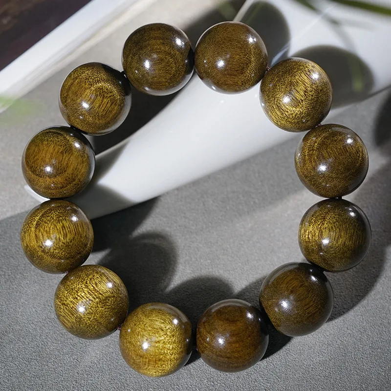 Handmade bracelet made from reclaimed old with , featuring dark golden silk patterns on aged wood, suit