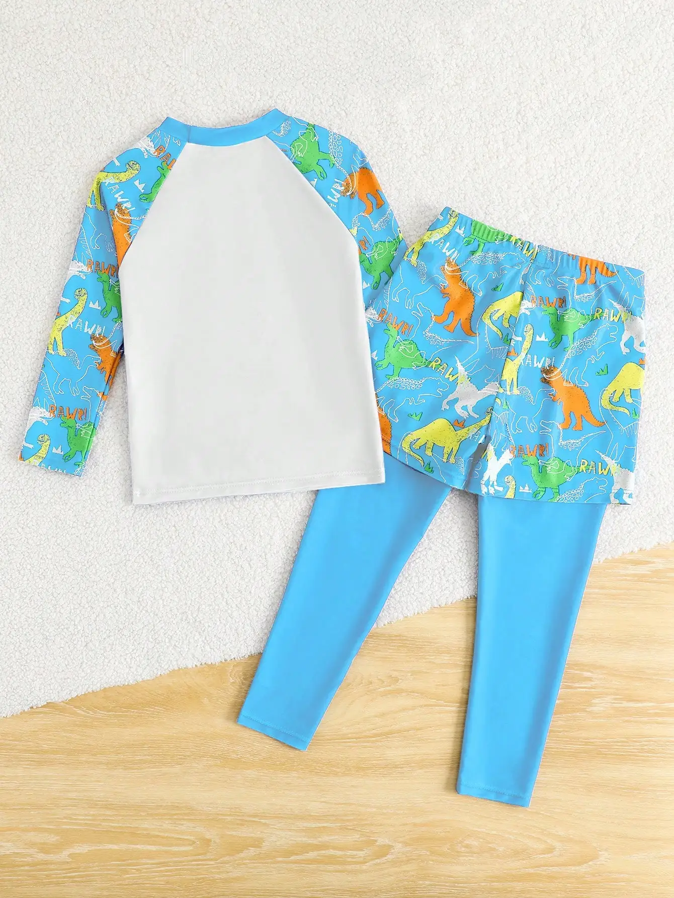 

Комплект для плавания из двух предметов для взрослых: лонгслив с защитой от УФ-излучения и леггинсы с принтом динозавров, синий