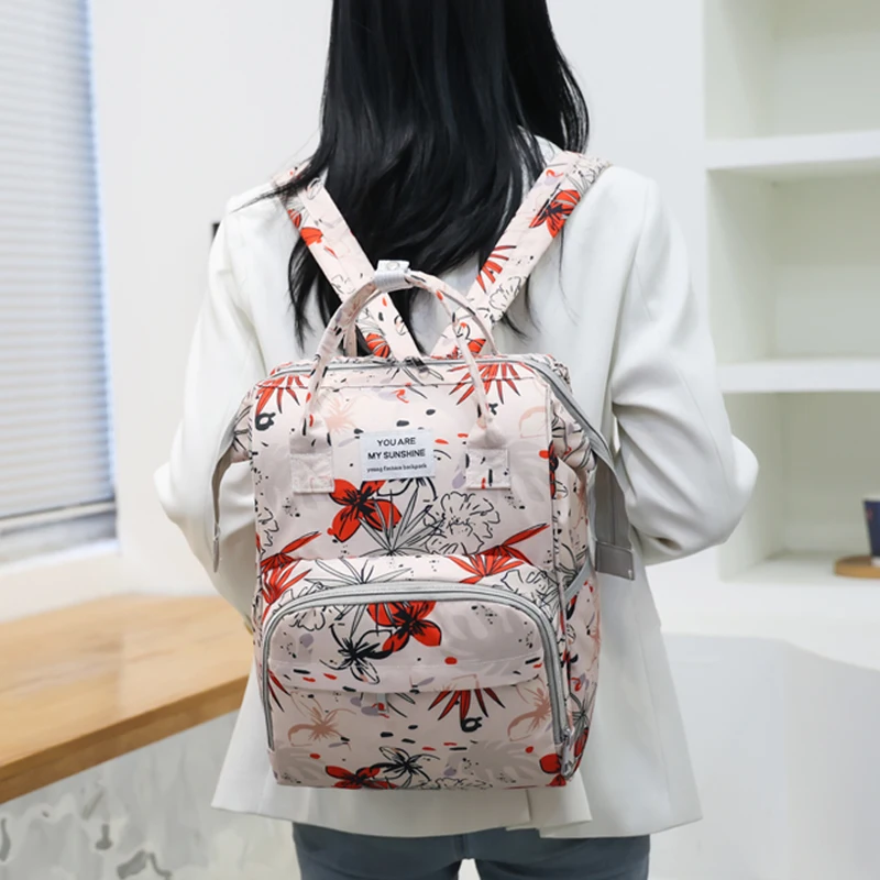 A lady pink orchid white peach pattern fashion trend mother and baby bag, suitable for daily use with children out