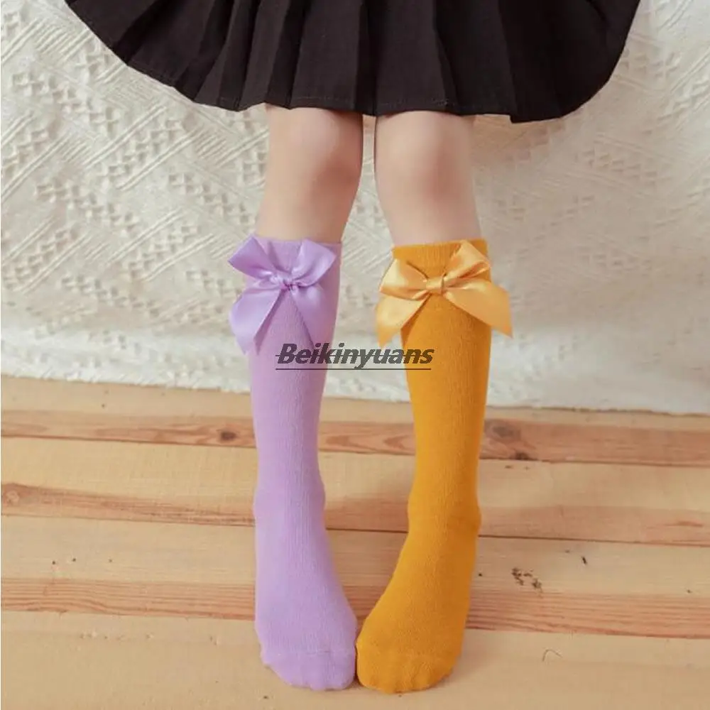 

New children's bow candy-colored pile socks Korean cute straight socks can wear solid cotton stockings before and after.