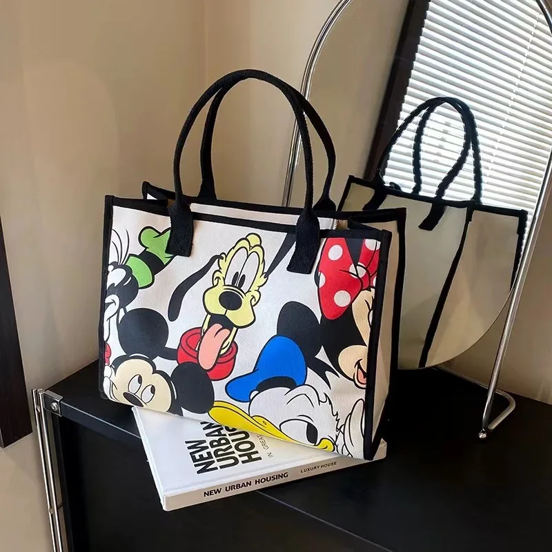 2025 New Disney Cartoon Animation Handheld Travel Shoulder Tote Bag Commuting Canvas Bag Female Mommy Bag Large Capacity Bag