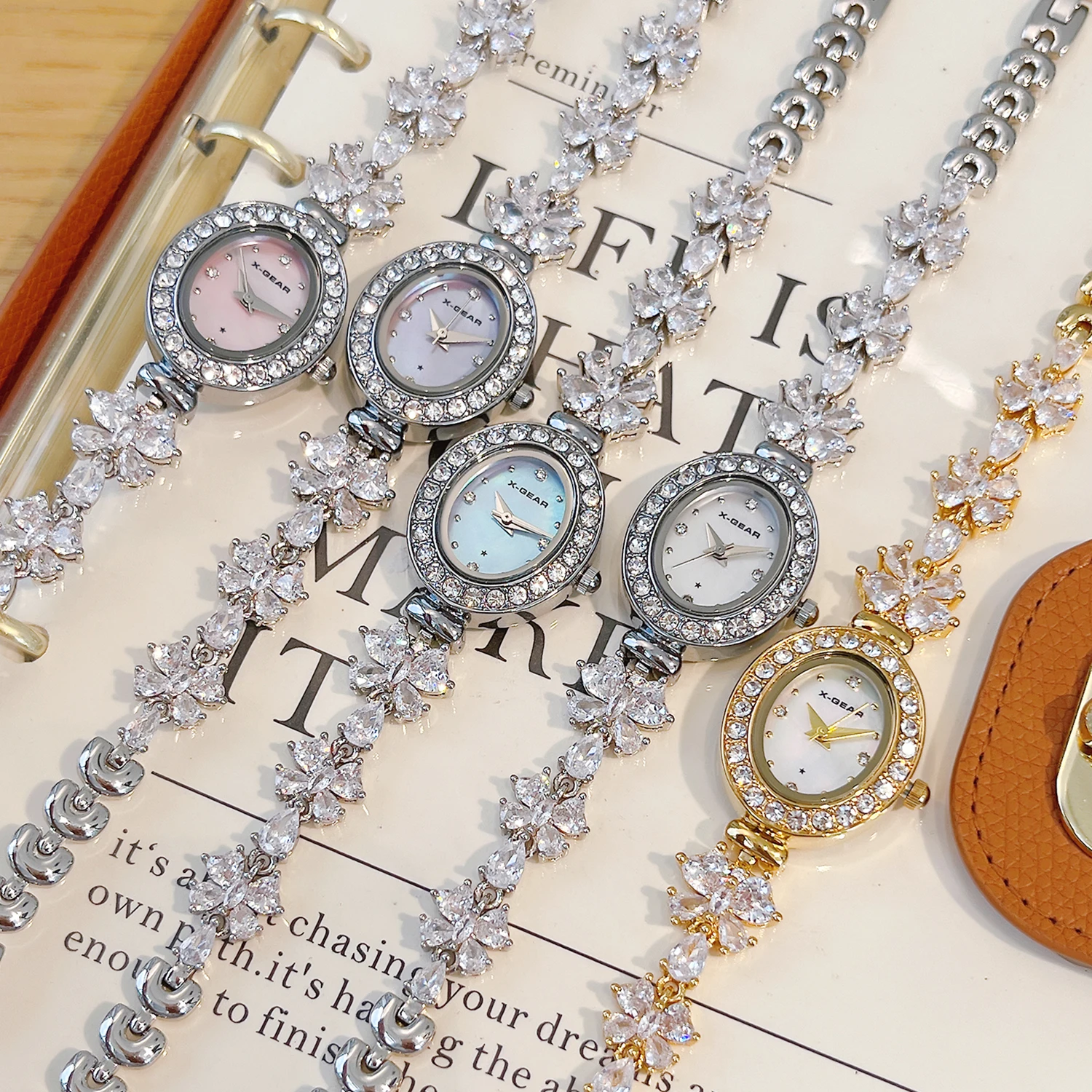 X-GEAR New Fashion Ellipse Ribbon-Strap Diamond-Studded Flower Watch Mother-of-Pearl for Women with Adjustable Bracelet