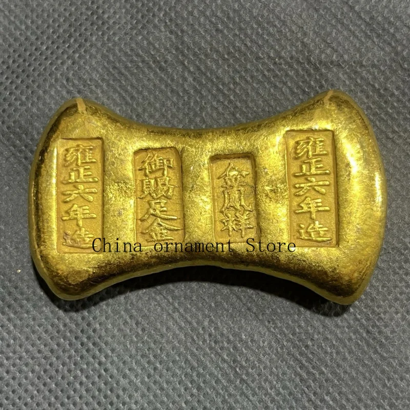 Vintage solid gold ingot coins, made during the Yongzheng reign, featuring a design of a golden phoenix and auspicious symbols,