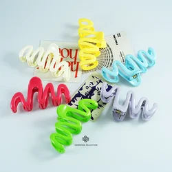 Creamy dopamine hairpin on the back of the woman's head with a shark clip  simple grip clip pinzas para el cabello