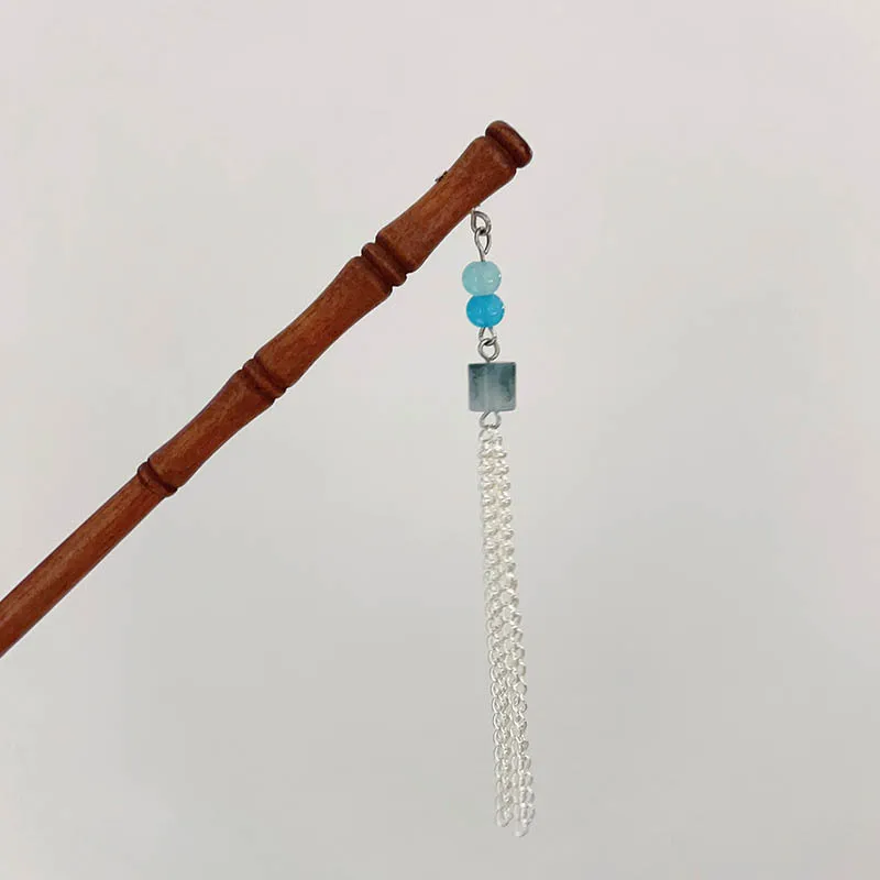 

A retro and simple bamboo hairpin with coiled hair and tassels