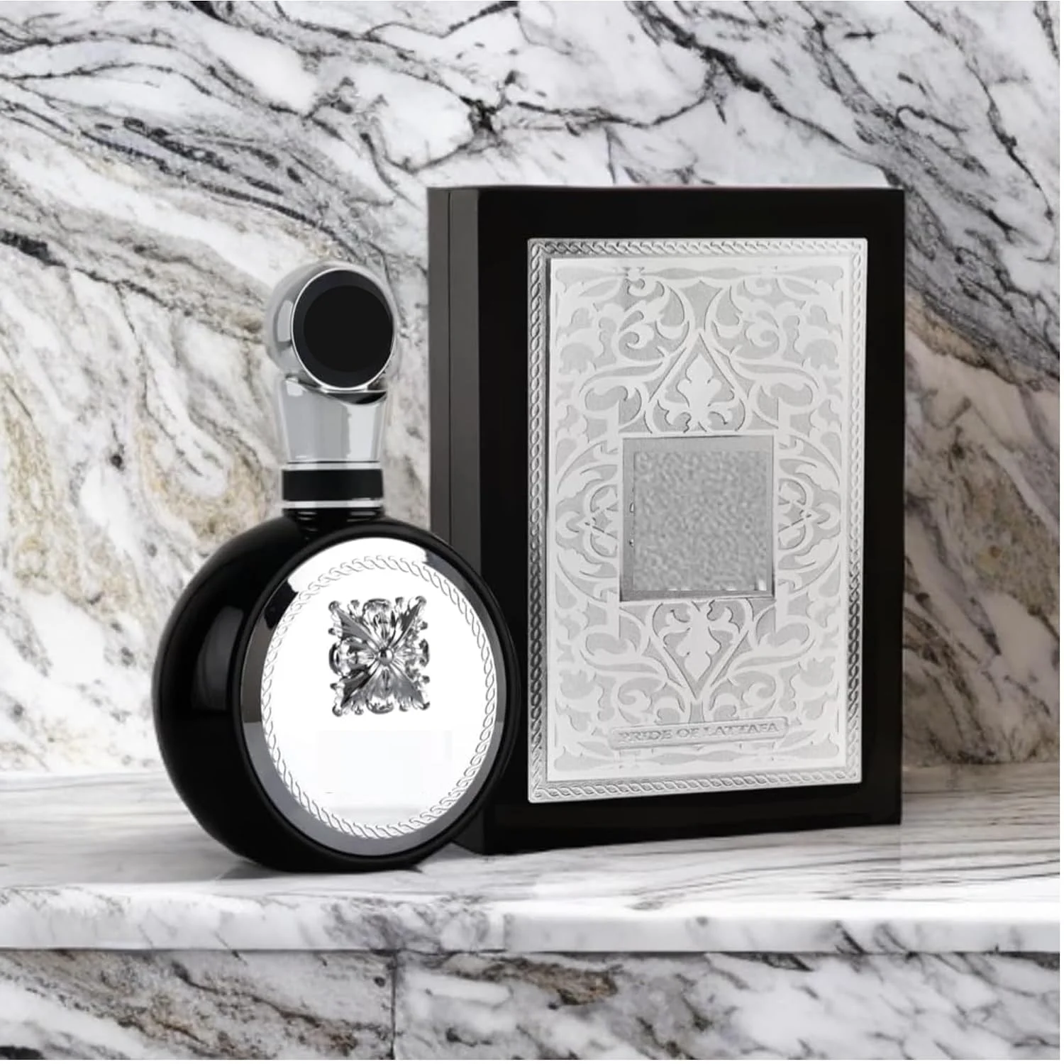 Latafa Fahreel Unisex Perfume, Floral Fragrance. The Bottle Has a Unique Round Shape, Featuring Black and Silver Colors, and Is Adorned with a Silver Three-Dimensional Engraved Label on The Top. Suitable for Commuting to Work,Business Meetings and Evening