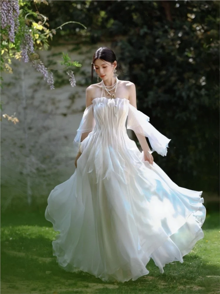 

A light flowing strapless hand-pleated morning dress with broken feel