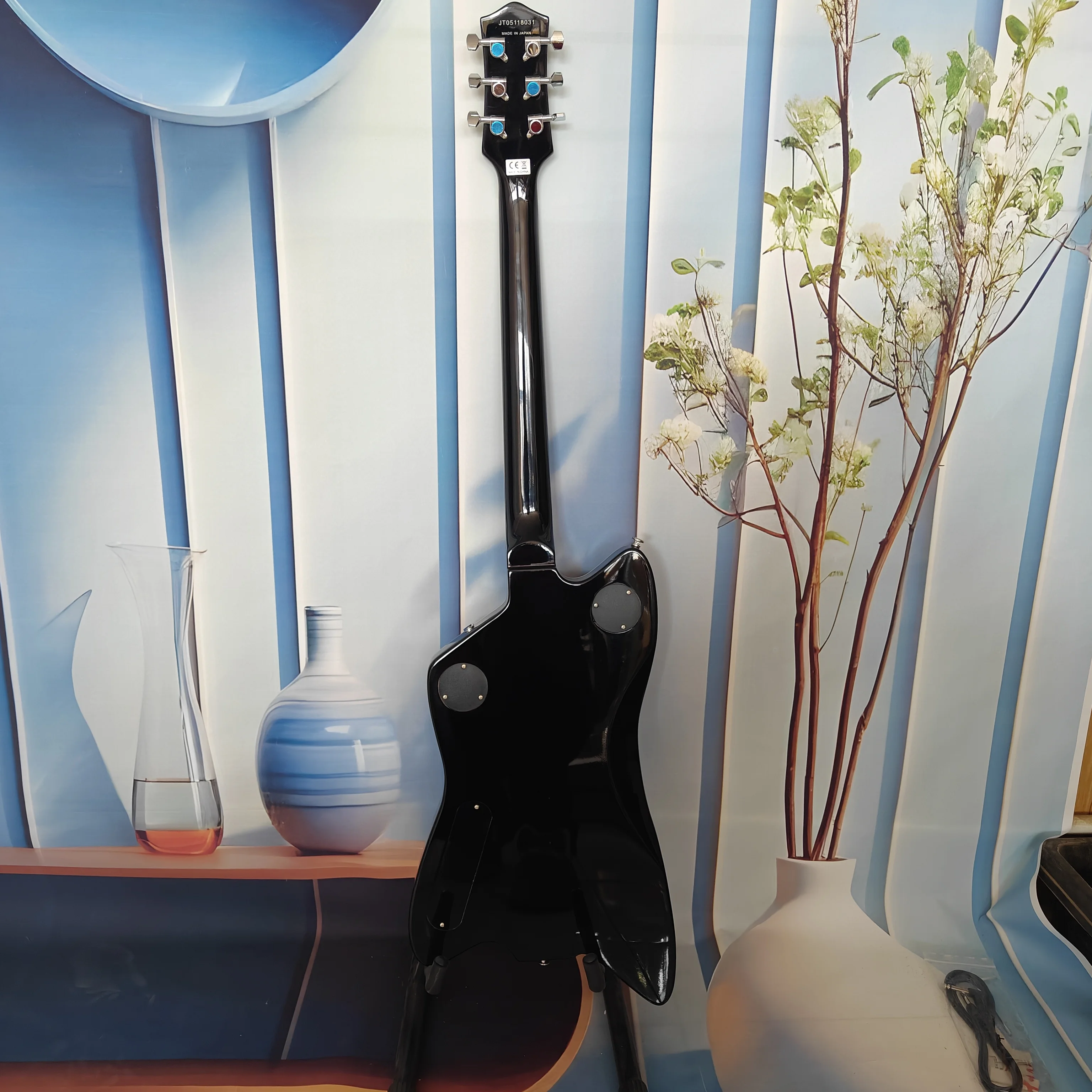 A high-quality acoustic-electric guitar with solid wood body, black pickguard, high-quality pickups, stainless steel frets, 22