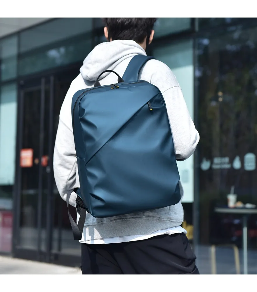 Navy minimalist backpack diagonal front zipper smooth satin surface slim structured design lightweight fabric suitable for daily