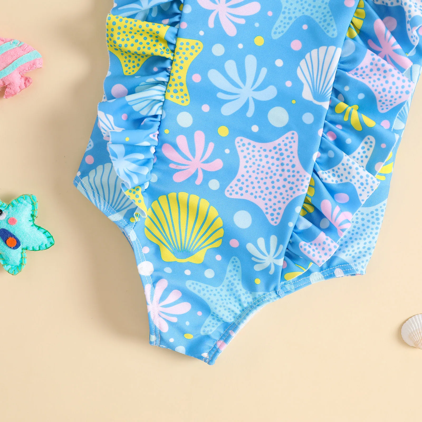 Toddler one piece swimsuit with ruffle and starfish shell ocean pattern for beach and pool water play