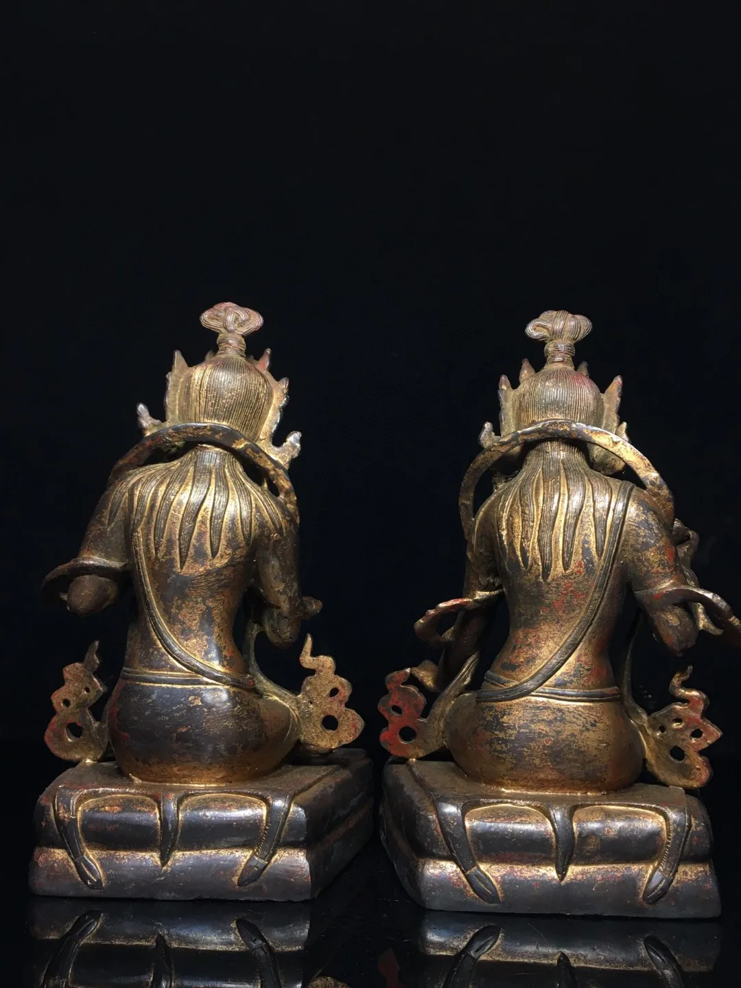 A pair of Tibetan brass clay, gold and cinnabar, depicting the protection of the Goddess of Mercy, Bodhisattva, and the mother o