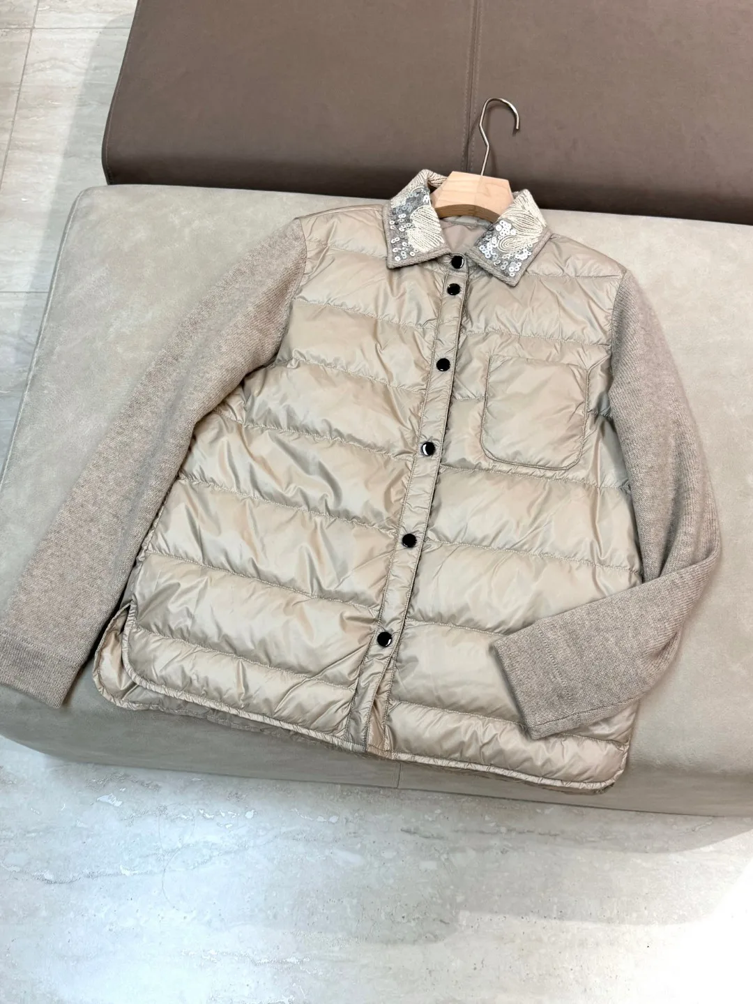 Exquisitely trimmed luxurious solid color down padded single breasted jacket