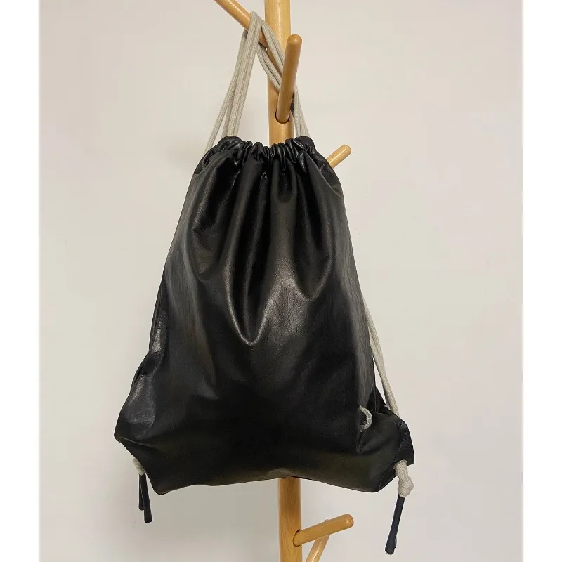 

Drawstring Cowhide Leather Backpack Unisex Casual Travel Bag Convertible to Single Shoulder & Dual Shoulder Bag