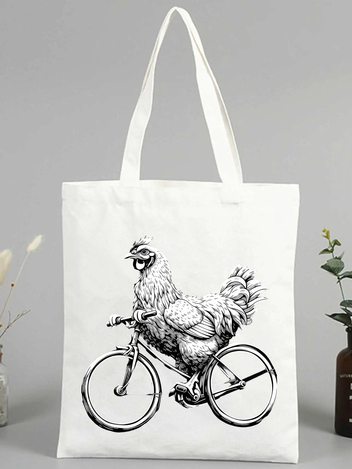 Women's canvas tote bag with chicken riding bicycle graphic, casual style for daily shopping and outings