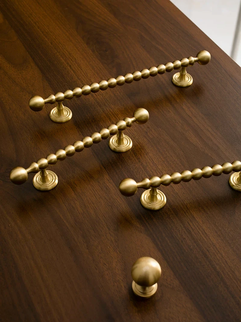 Beaded cabinet handle in brushed brass shown in the supplier product illustration 15