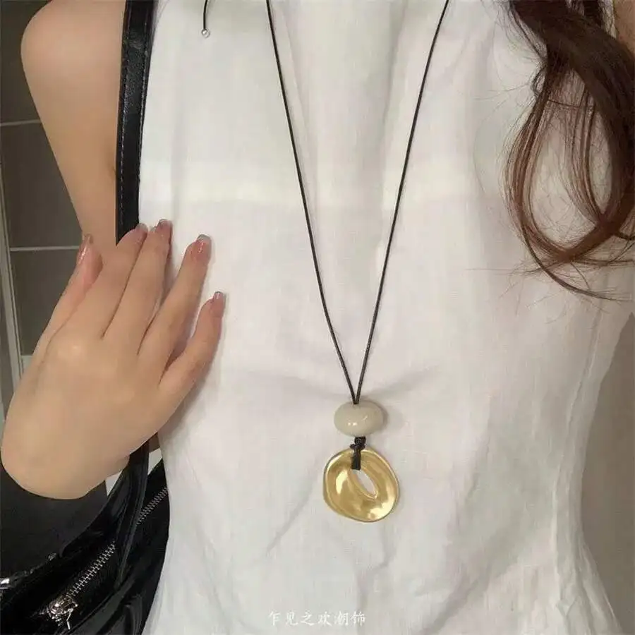

Water drop acrylic pendant on leather cord necklace