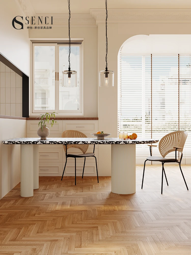 Terrazzo dining table is luxurious and high-grade. Black and white marble semicircle dining table is against the wall.