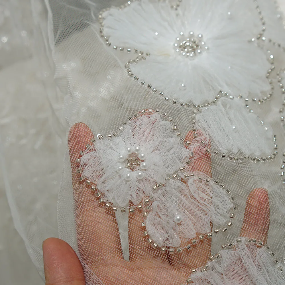 The new irregular three-dimensional floral beaded and sequined lace fabric is suitable for wedding parties