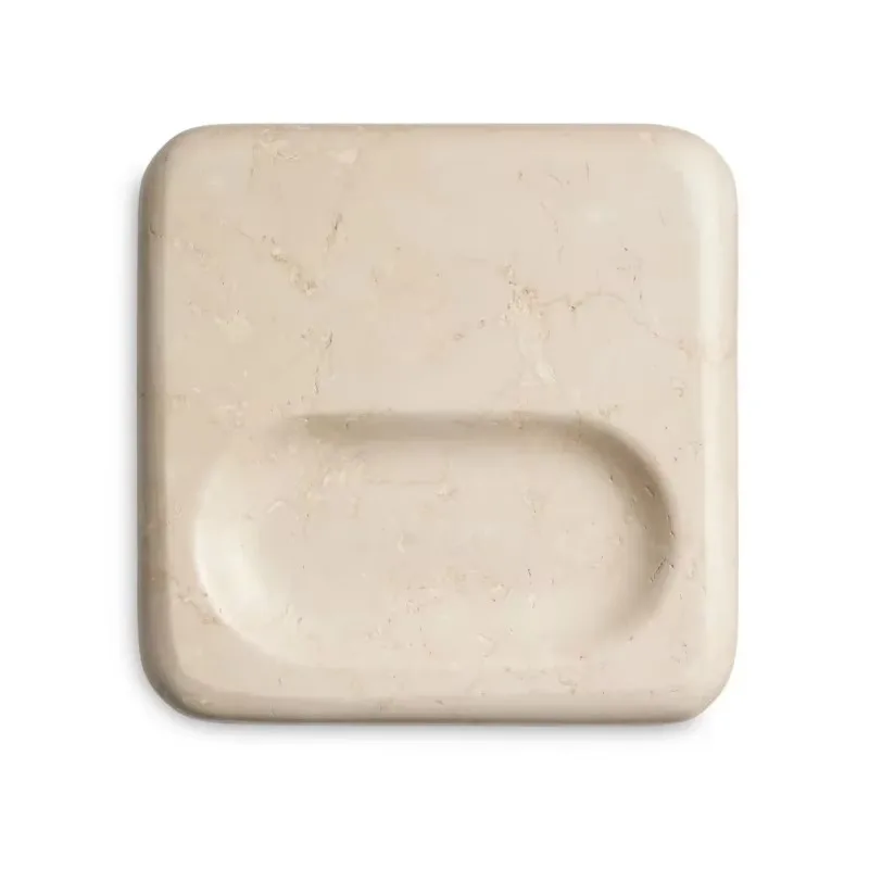 Cream-colored marble decorative plate with mafic stone texture