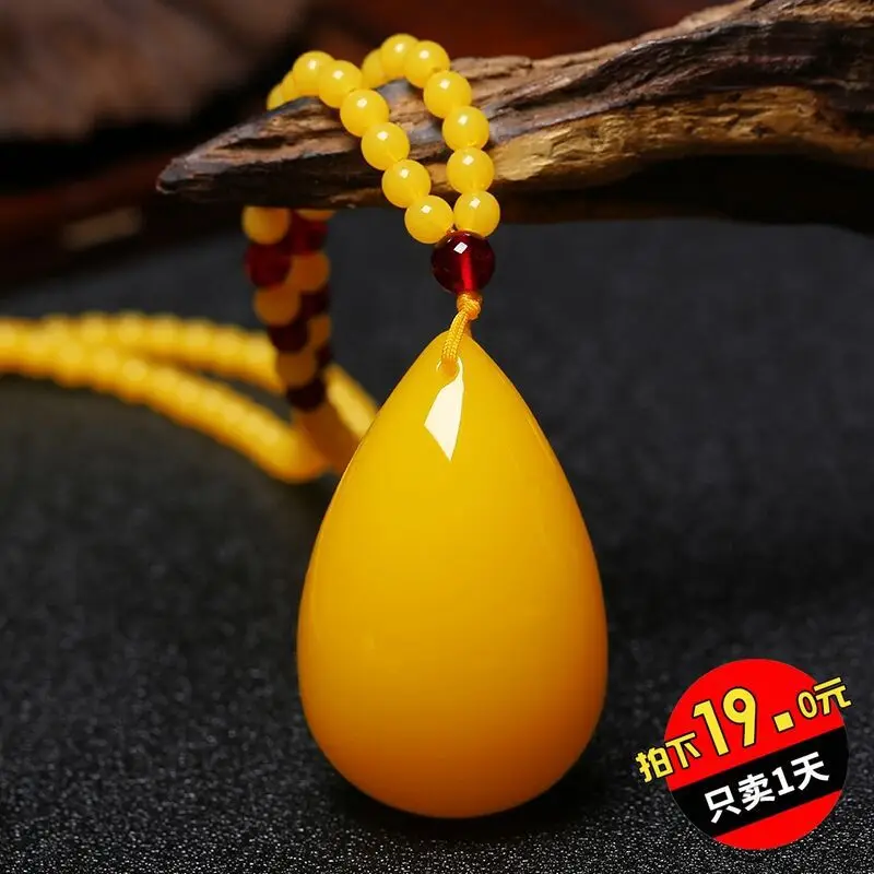 Second-generation amber water drop pendant in chicken oil yellow, freeform carving with rose flower design, sweater chain