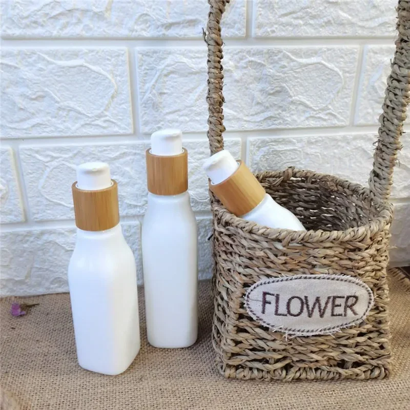 

Hot Selling beauty Porcelain White Glass square White Opal Glass Lotion Bottle Essential Oil bottle with Bamboo wooden Cap