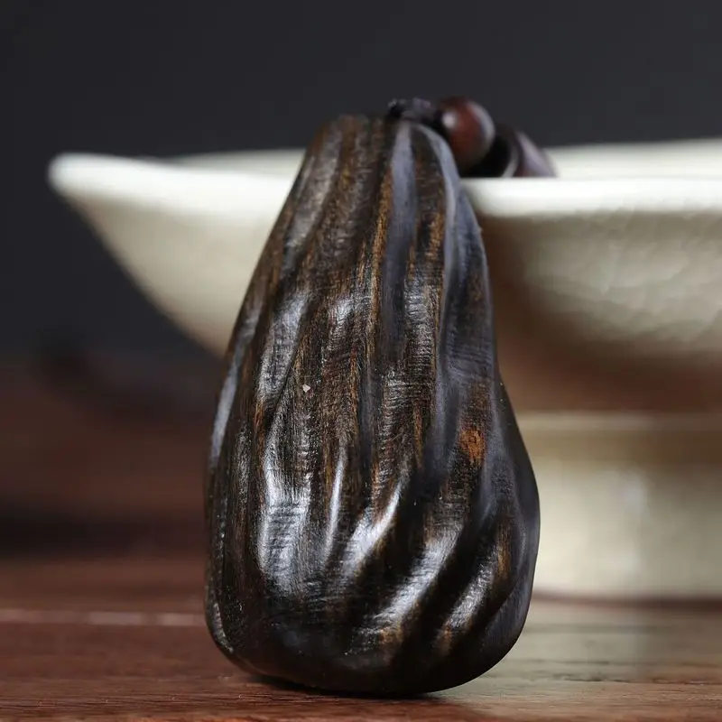 Natural Vietnamese agarwood pendant with insect-carved details, hand-held ornament, decorative piece, and necklace