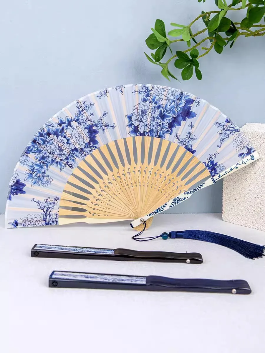 Chinese classic folding fan, retro blue and white porcelain bamboo bone fan, hollowed out tassel dancing fan, home decoration