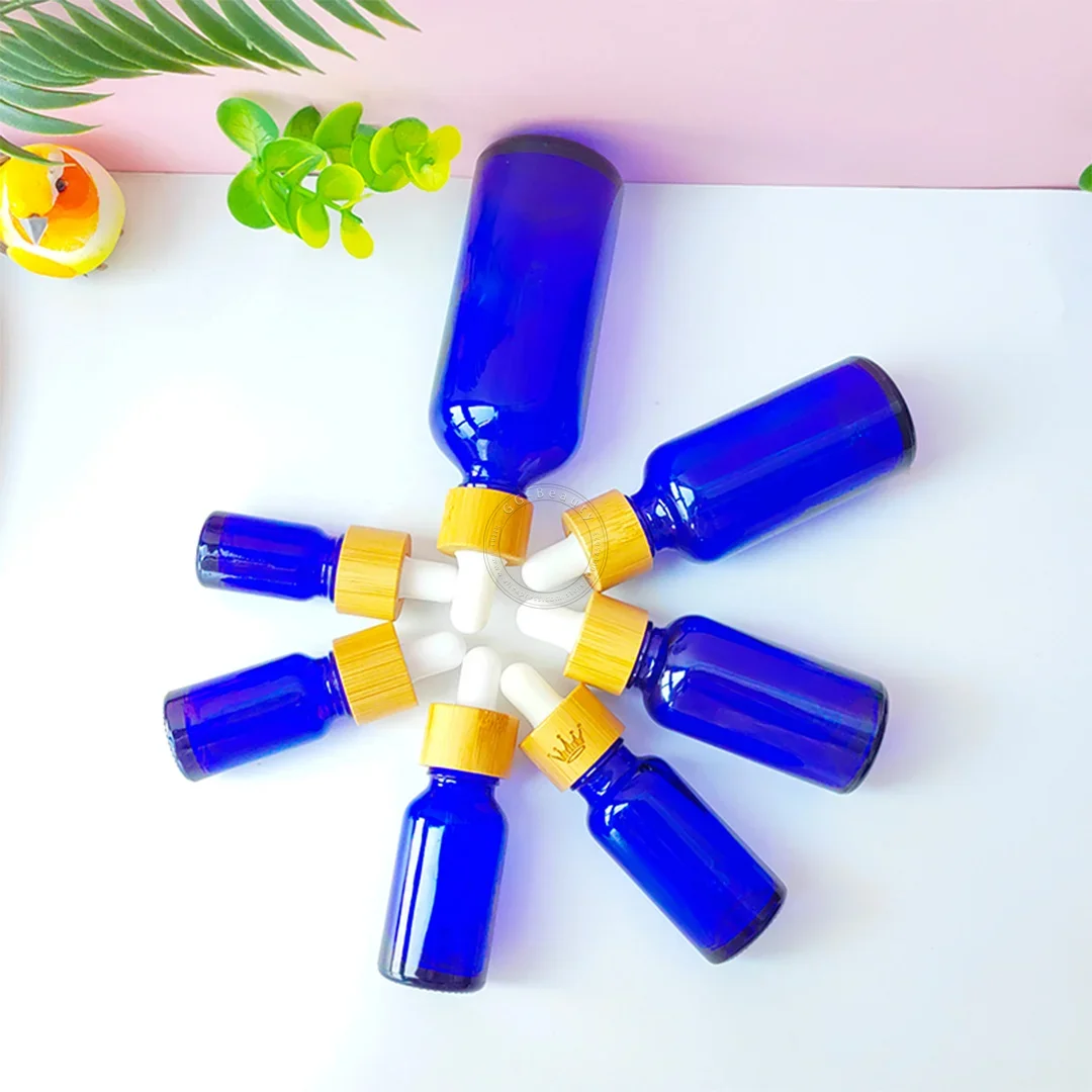 Whosesale frascos de garrafa conta-gotas de vidro âmbar/verde/azul/preto de alta qualidade com tampa de bambu pipeta para garrafas de perfumes cosméticos