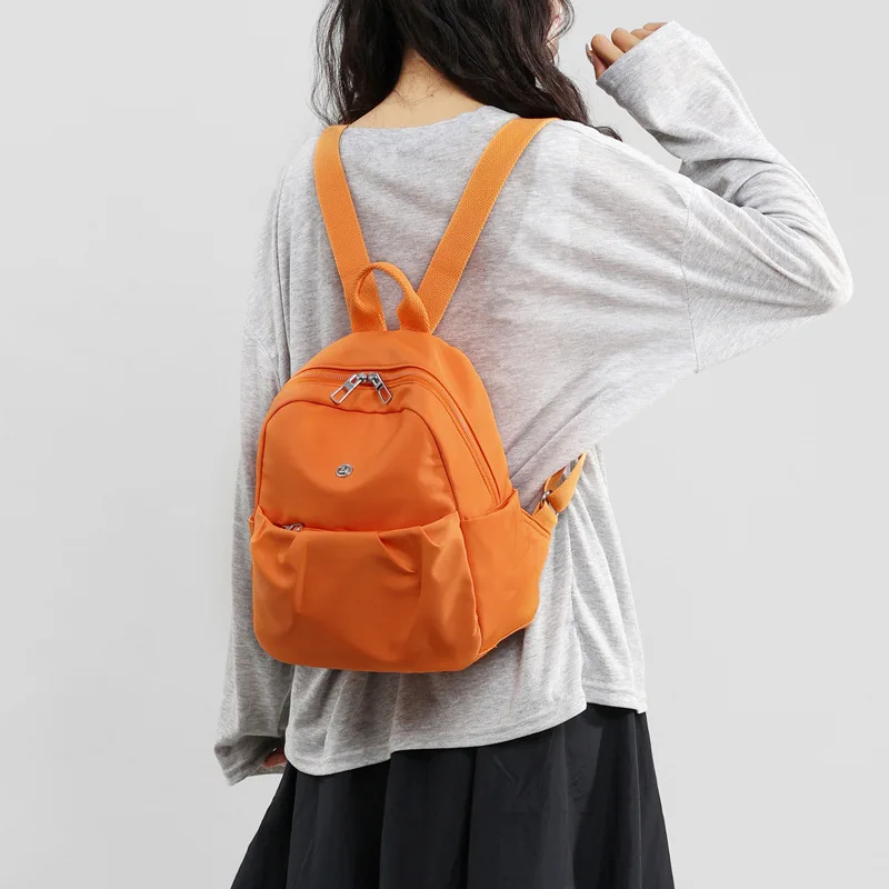 2026 New Arrival Minimalist Water Resistant Nylon Backpack Lightweight Casual School Bag Fits 12 Inch Laptop Portable Carry On