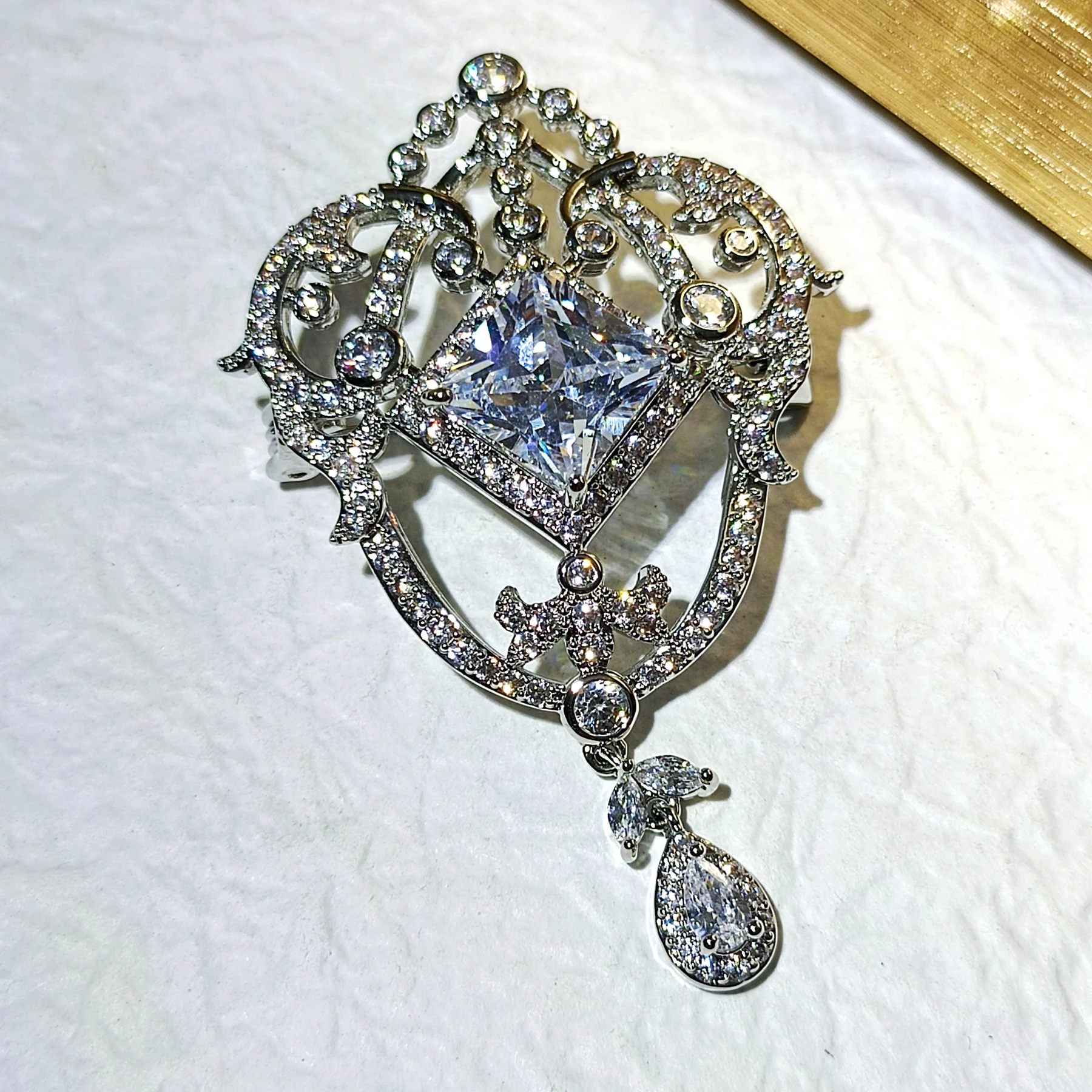 Magnificent Silver tone Opens Garland Style Square Stone Accent Brooch with Pear Drop