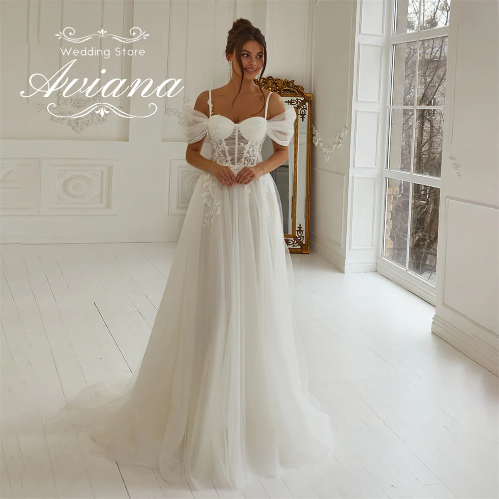 

Aviana индивидуальное свадебное платье трапециевидной формы на тонких бретельках с открытыми плечами и скользящим шлейфом Aqqliques корсет из тюля с пайетками