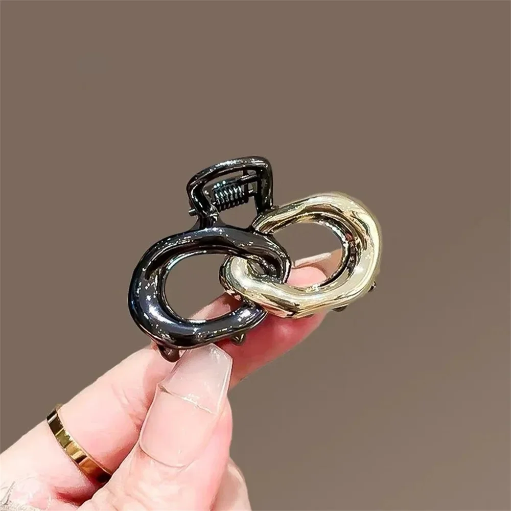 Small Hair Claw Clip Women Dual Interlocking Loop Design Glossy Black and Gold Plated Metal Alloy view 2