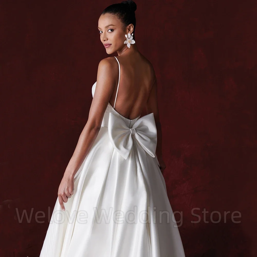 セクシーなオープンバック A ライン ブライダル ウェディング ドレス スパゲッティ ストラップ ノースリーブ リボン付き フロアレングス スイープ トレイン カスタム メイド ガウン