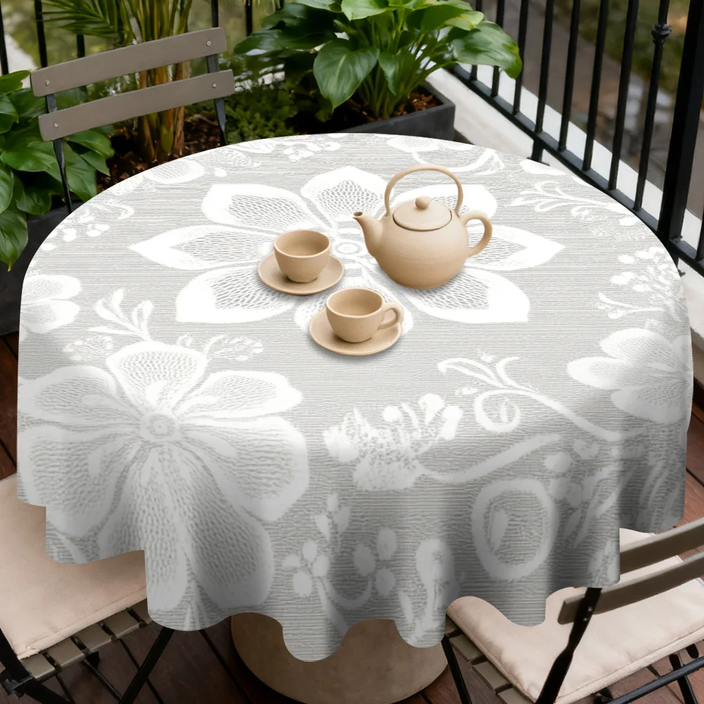 A floral design round tablecloth adds ambience to the table, perfect for holiday meals and home decor