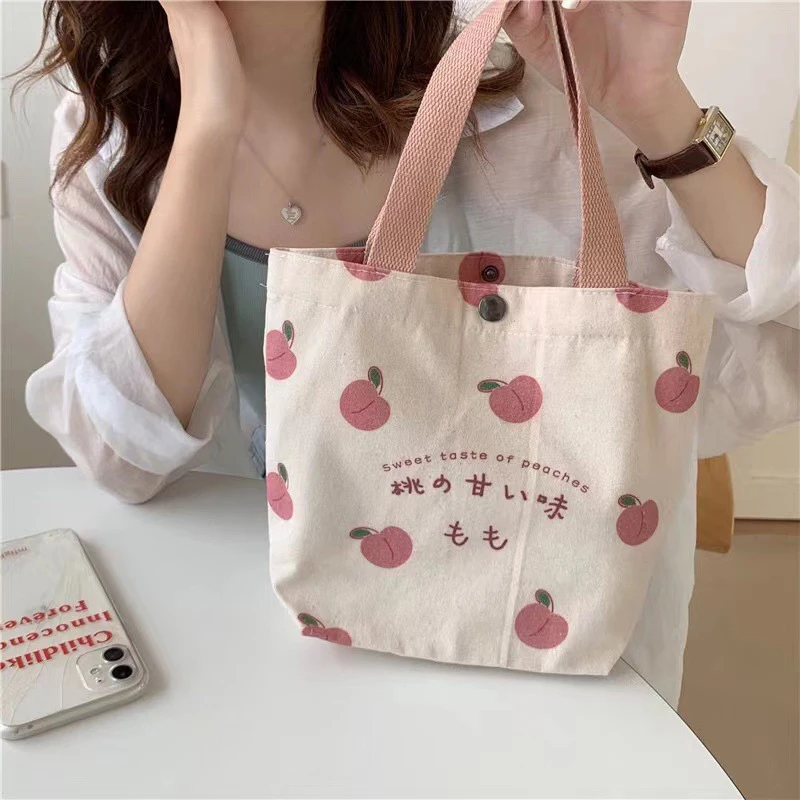 小さなキャンバス女性用トートフードバッグ日本の桃柄ハンドランチバッグ韓国ミニ学生ハンドバッグ綿布ピクニック旅行弁当バッグ 1